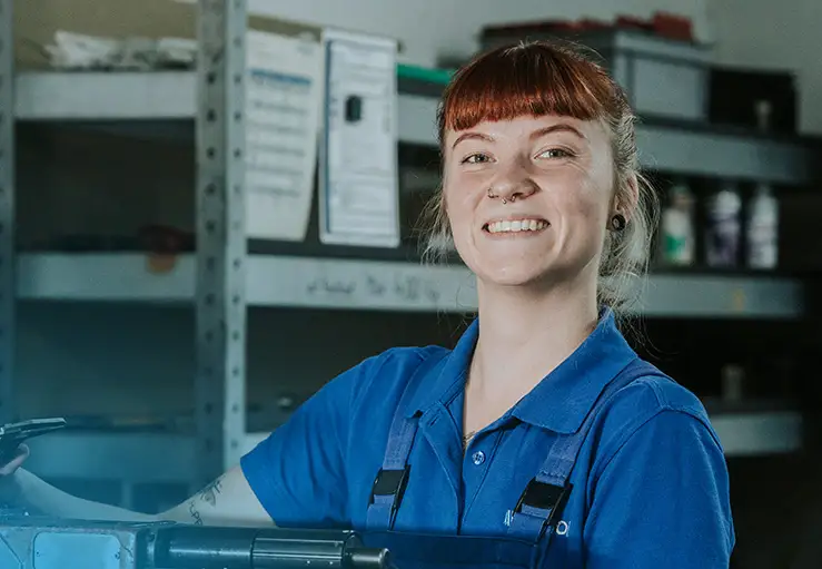 Pieron apprentice at a machine in the workshop