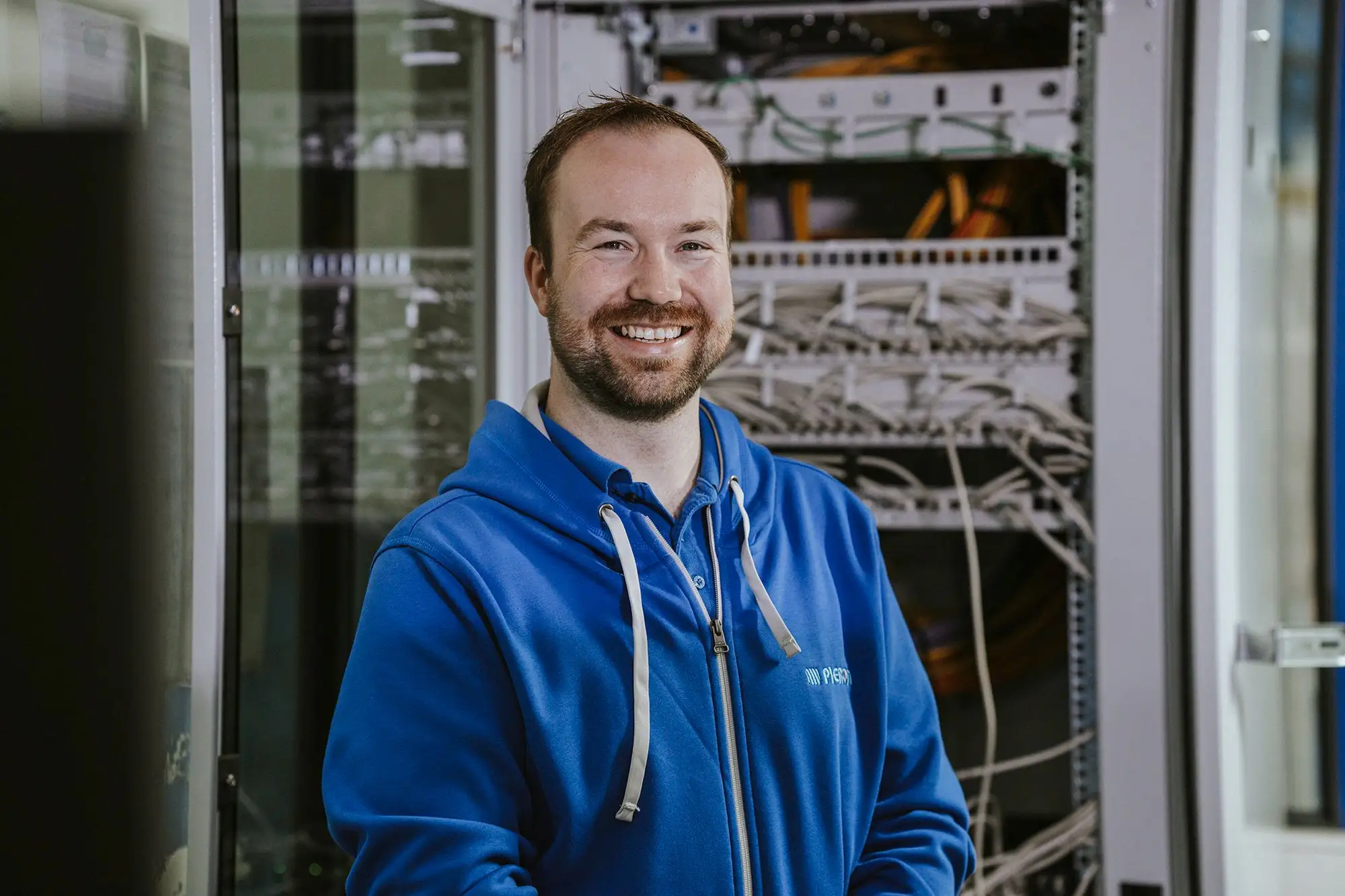 Pieron employee in front of a server cabinet in the IT department
