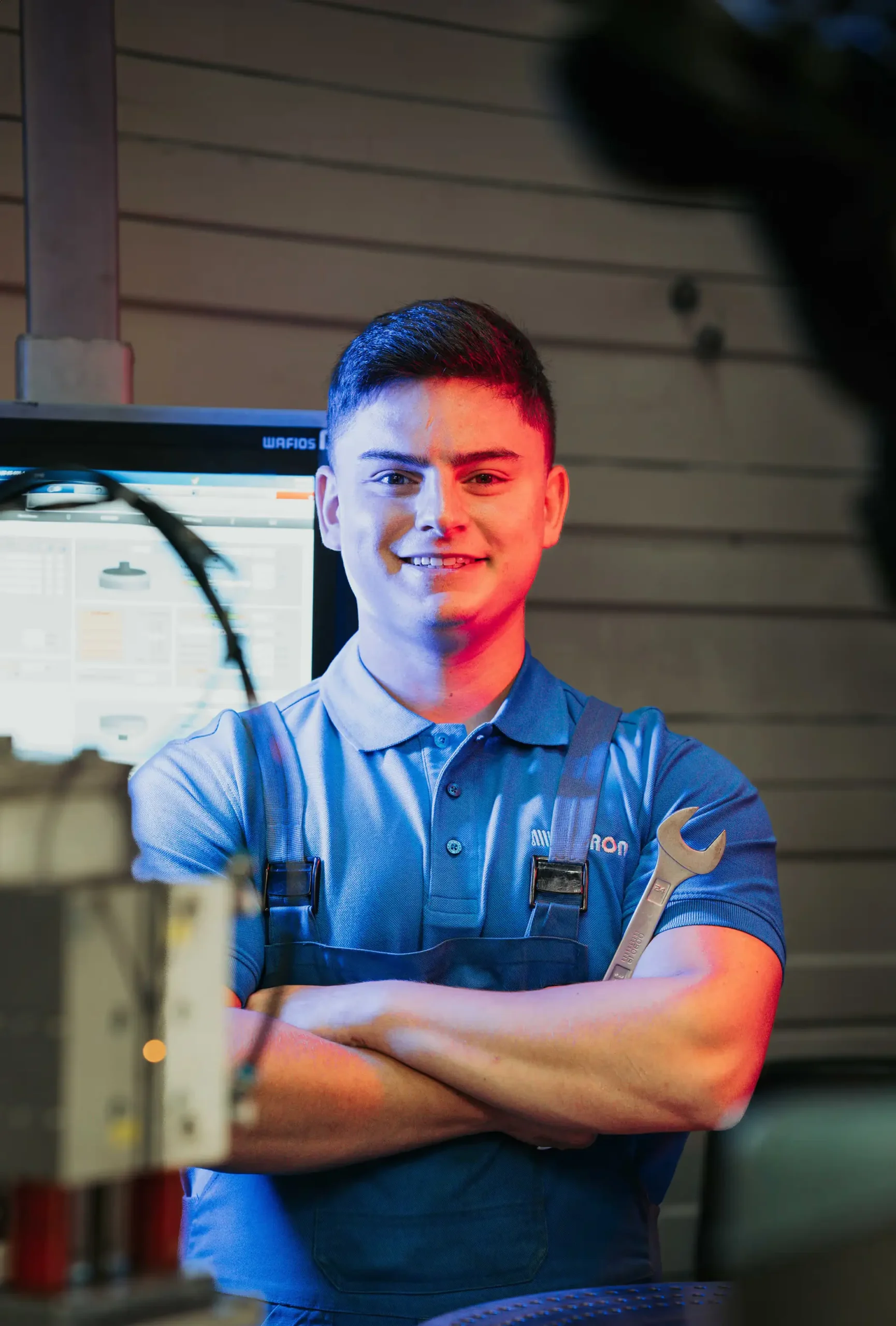 Pieron employee with arms crossed in the workshop